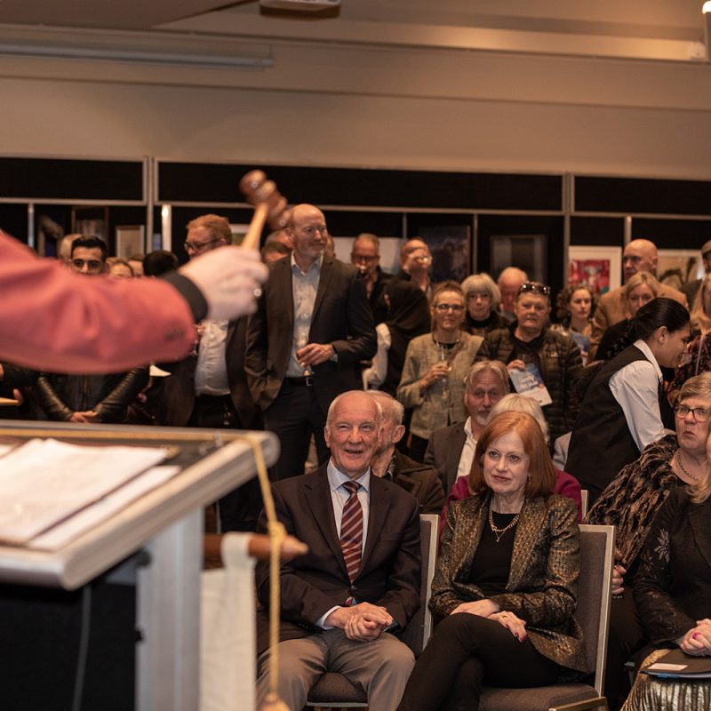 An auction in front of a crowded room